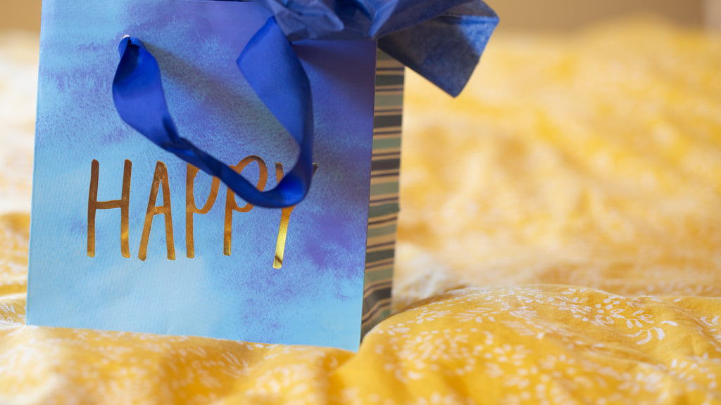 files/blue-gift-bag-with-gold-lettering.jpg